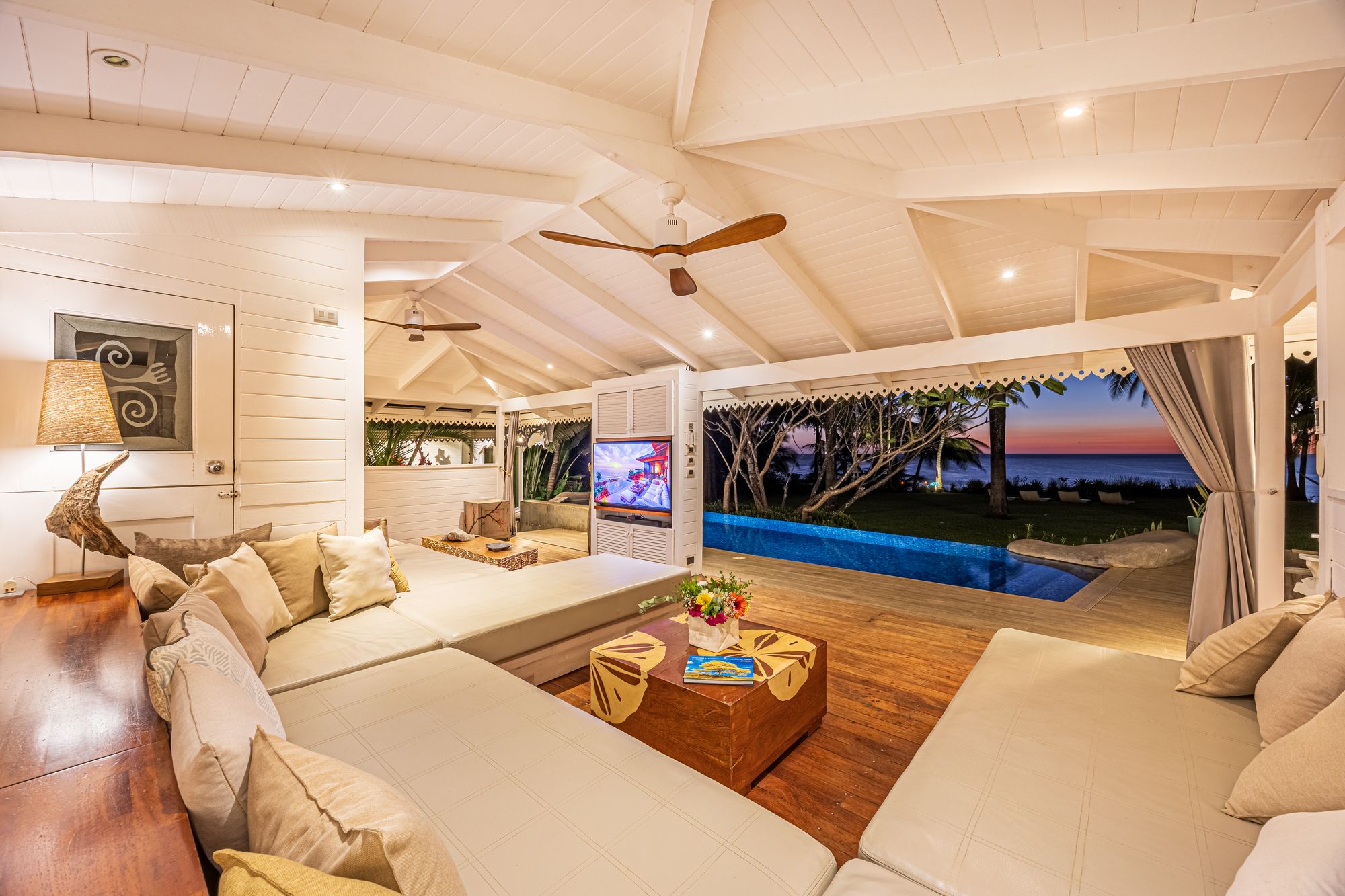 Living room with pool and sunset views